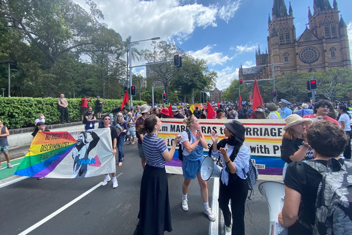 LGBT protestors march at George Pell’s funeral